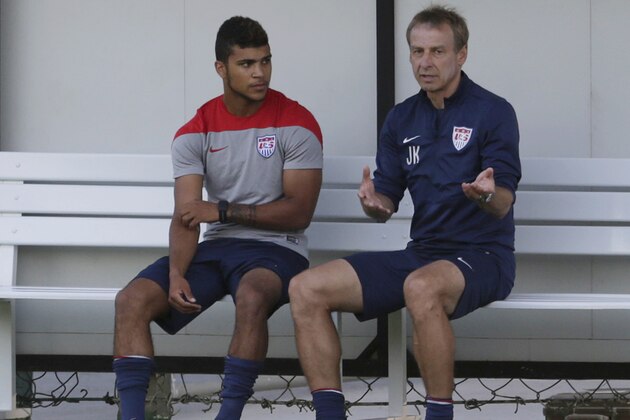United States' head coach Jurgen Klinsmann, right, talks to DeAndre Yedlin during a training session in Sao Paulo, Brazil, Monday, June 23, 2014. The United States will play Germany in group G of the 2014 soccer World Cup on June 26 in Recife, Brazil. (AP Photo/Julio Cortez)