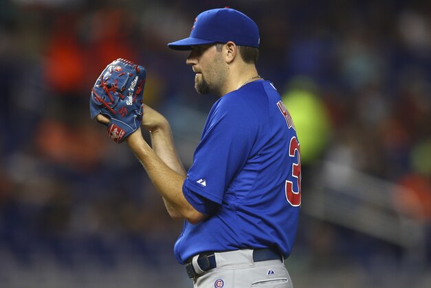 Chicago Cubs starter Jason Hammel studies a Miami Marlins batter after giving a two-run home run during the first inning of a baseball game in Miami, Monday, June 16, 2014. (AP Photo/J Pat Carter)