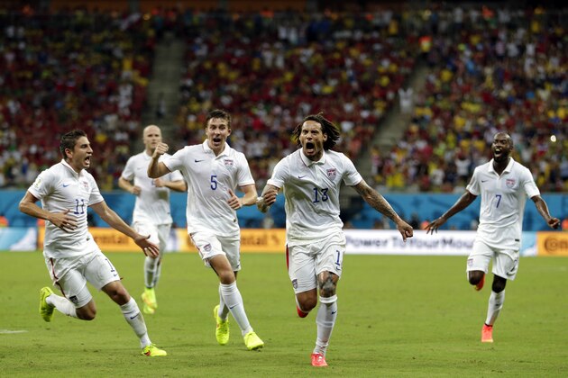 United States' Jermaine Jones (13) celebrates with his teammates after scoring his side's first goal during the group G World Cup soccer match between the United States and Portugal at the Arena da Amazonia in Manaus, Brazil, Sunday, June 22, 2014. (AP Photo/Julio Cortez)