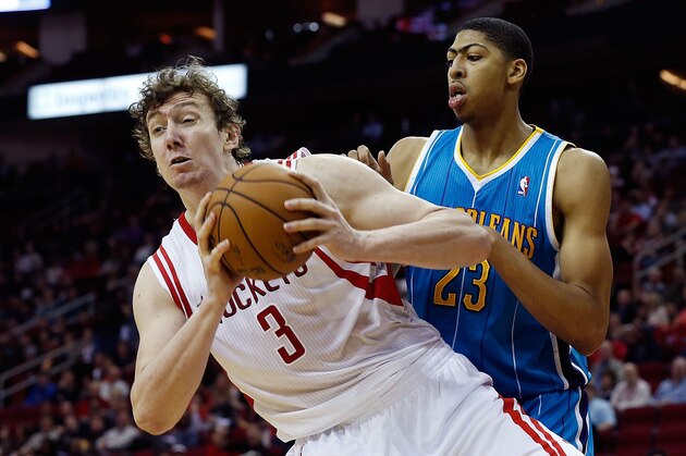 HOUSTON, TX - JANUARY 02:  Omer Asik #3 of the Houston Rockets grabs a rebound in front of Anthony Davis #23 of the New Orleans Hornets at Toyota Center on January 2, 2013 in Houston, Texas.  NOTE TO USER: User expressly acknowledges and agrees that, by downloading and or using this photograph, User is consenting to the terms and conditions of the Getty Images License Agreement.  (Photo by Scott Halleran/Getty Images)