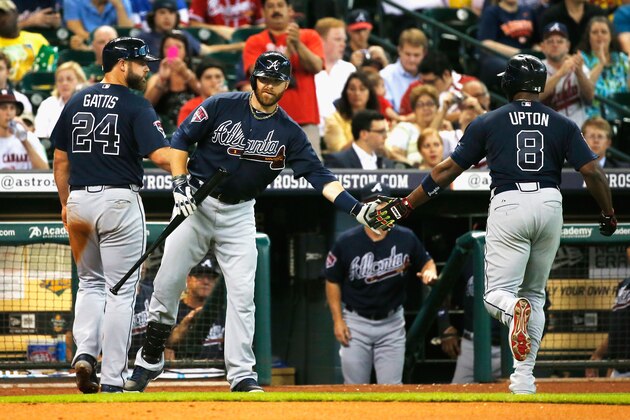 HOUSTON, TX - JUNE 25:  Ryan Doumit (C) #4 of the Atlanta Braves greets Evan Gattis #24 and Justin Upton #8 after Upton hit a sacrifice fly to score Gattis in the second inning of their game against the Houston Astros at Minute Maid Park on June 25, 2014 in Houston, Texas.  (Photo by Scott Halleran/Getty Images)