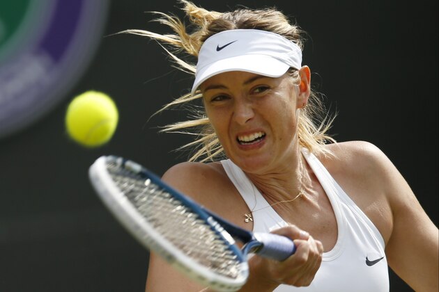 Maria Sharapova of Russia plays a return to Samantha Murray of Britain during their first round match at the All England Lawn Tennis Championships in Wimbledon, London,  Tuesday, June  24, 2014. (AP Photo/Pavel Golovkin)