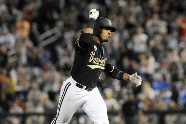 Vanderbilt's John Norwood celebrates as he runs the bases after hitting a home run against Virginia in the eighth inning of Game 3 of the best-of-three NCAA baseball College World Series finals in Omaha, Neb., Wednesday, June 25, 2014. (AP Photo/Eric Francis)
