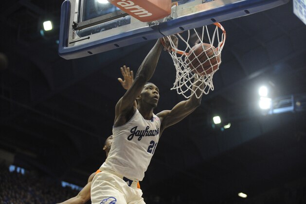 Jan 18, 2014; Lawrence, KS, USA; Kansas Jayhawks center Joel Embiid (21) dunks the ball against Oklahoma State Cowboys guard Markel Brown (22) in the second half at Allen Fieldhouse. Kansas won 80-78. Mandatory Credit: John Rieger-USA TODAY Sports
