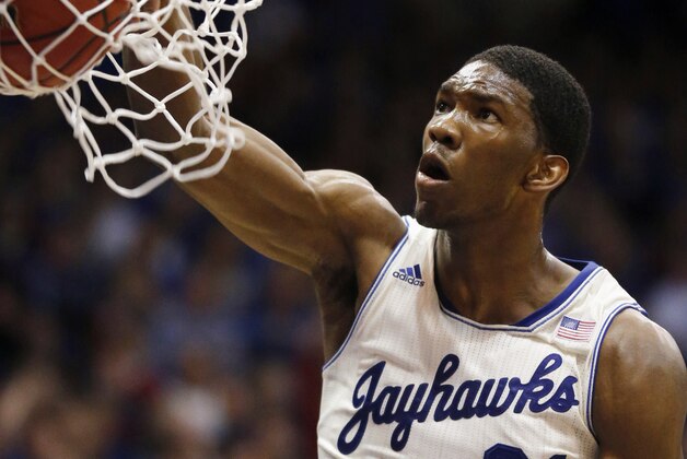 Kansas center Joel Embiid dunks during the first half of an NCAA college basketball game against Texas in Lawrence, Kan., Saturday, Feb. 22, 2014. (AP Photo/Orlin Wagner)