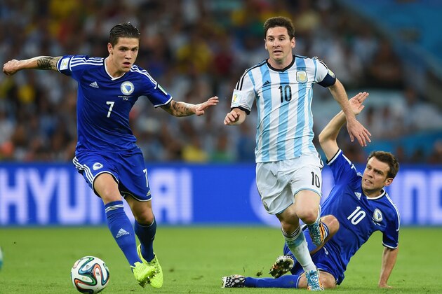 RIO DE JANEIRO, BRAZIL - JUNE 15:  Lionel Messi of Argentina dribbles past Muhamed Besic of Bosnia and Herzegovina to score his team's second goal during the 2014 FIFA World Cup Brazil Group F match between Argentina and Bosnia-Herzegovina at Maracana on June 15, 2014 in Rio de Janeiro, Brazil.  (Photo by Matthias Hangst/Getty Images)