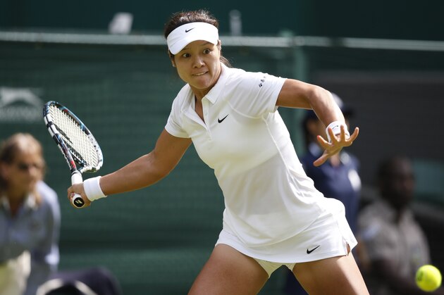 Li Na of China plays a return to Paula Kania of Poland during their first round match at the All England Lawn Tennis Championships in Wimbledon, London,  Monday, June  23, 2014. (AP Photo/Pavel Golovkin)