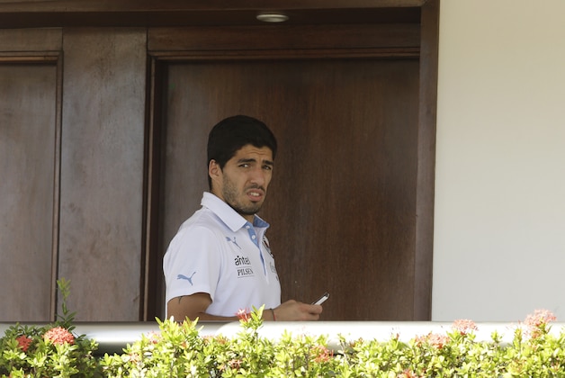 Uruguay's Luis Suarez uses his cell phone at a hotel in Natal, Brazil, Wednesday, June 25, 2014. Suarez bit Italian player Giorgio Chiellini during Uruguay's game with Italy on Tuesday, which could lead to Suarez being kicked out of the World Cup. (AP Photo/Hassan Ammar)