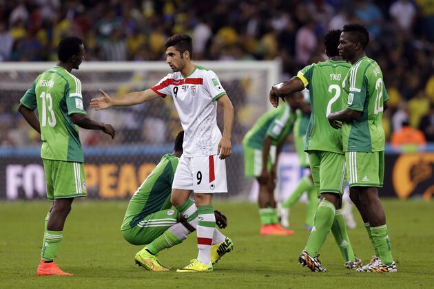 Iran's Alireza Jahanbakhsh, centre, reaches out to shake hands with Nigeria's Juwon Oshaniwa after the group F World Cup soccer match between Iran and Nigeria at the Arena da Baixada in Curitiba, Brazil, Monday, June 16, 2014. The match ended in a 0-0 draw. (AP Photo/Fernando Vergara) Iran's Alireza Jahanbakhsh, centre, reaches out to shake hands with Nigeria's Juwon Oshaniwa after the group F World Cup soccer match between Iran and Nigeria at the Arena da Baixada in Curitiba, Brazil, Monday, June 16, 2014. The match ended in a 0-0 draw. (AP Photo/Fernando Vergara)