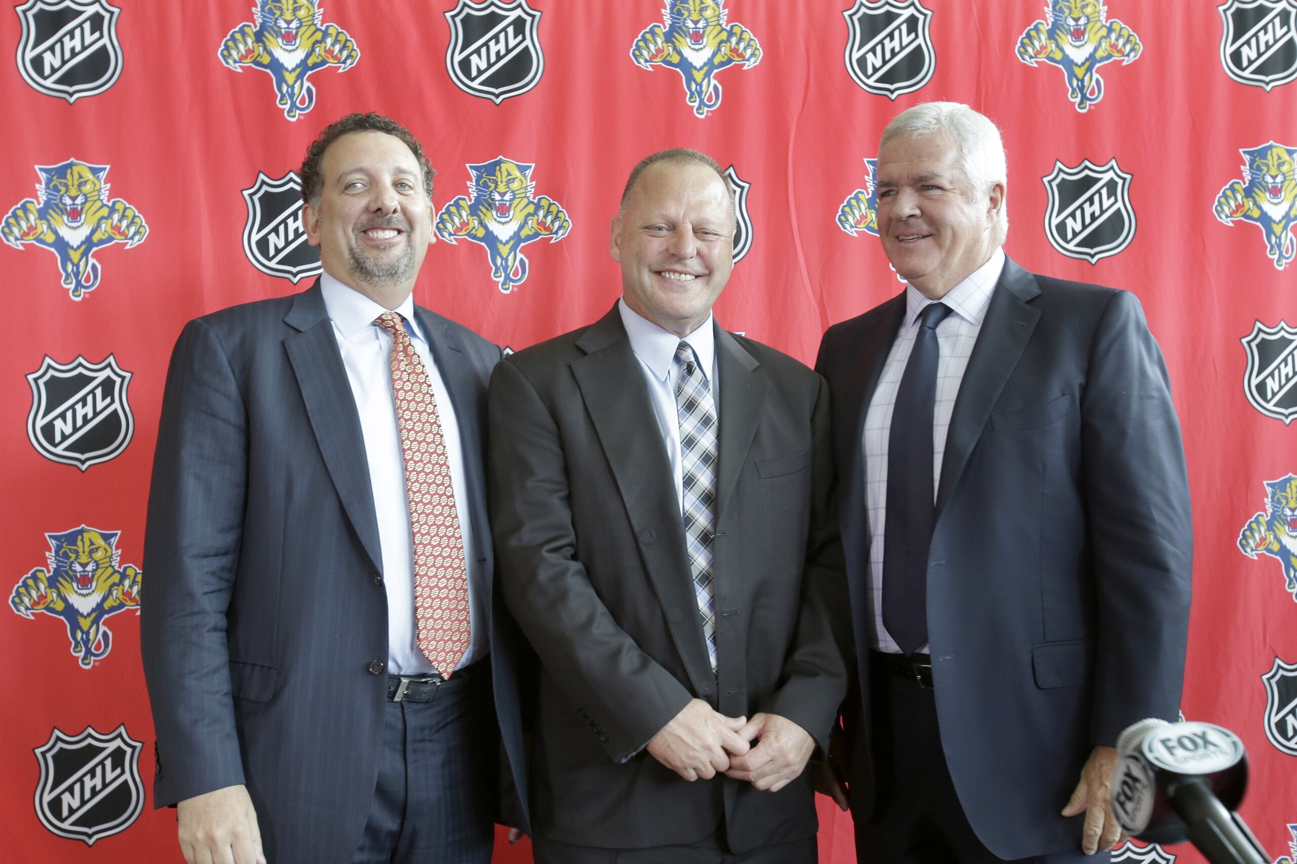 Gerard Gallant, center, newly named head coach of the Florida Panthers, poses for photos with Panthers' CEO and President Rory Babich, left, and General Manager and Executive Vice President Dale Tallon, right, after a news conference, Monday, June 23, 2014 in Sunrise, Fla. Gallant spent the last two seasons as an assistant with the Montreal Canadiens and saw there how quickly a team's fortunes can turn around. When he joined Montreal, the Canadiens were coming off a season where they finished last in the Eastern Conference. (AP Photo/Wilfredo Lee)