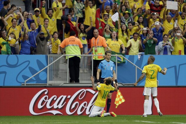 Brazil's Neymar celebrates with Dani Alves (2) after scoring his side's second goal during the group A World Cup soccer match between Cameroon and Brazil at the Estadio Nacional in Brasilia, Brazil, Monday, June 23, 2014. (AP Photo/Natacha Pisarenko)