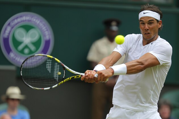 Rafael Nadal of Spain plays a return to Lukas Rosol of the Czech Republic during their men's singles match at the All England Lawn Tennis Championships in Wimbledon, London, Thursday, June 26, 2014. (AP Photo/Pavel Golovkin)