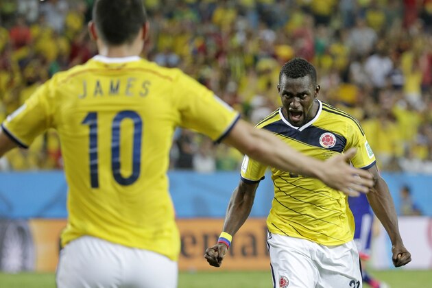 Colombia's Jackson Martinez, right, celebrates with teammate Colombia's James Rodriguez after scoring his teams third goal during the group C World Cup soccer match between Japan and Colombia at the Arena Pantanal in Cuiaba, Brazil, Tuesday, June 24, 2014. (AP Photo/Felipe Dana)