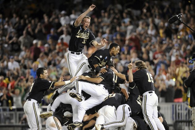 Vanderbilt players celebrate after Vanderbilt defeated Virginia 3-2 in the deciding game of the best-of-three NCAA baseball College World Series finals in Omaha, Neb., Wednesday, June 25, 2014. (AP Photo/Eric Francis)
