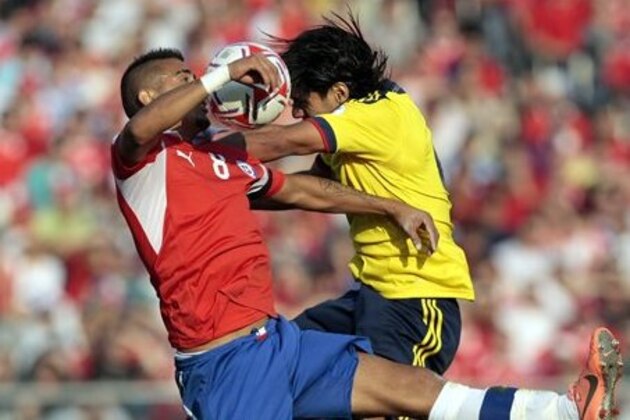 Chile's Arturo Vidal, left, fights for the ball with Colombia's Ramadel Falcao during a World Cup 2014 qualifying soccer game in Santiago, Chile, Tuesday, Sept. 11, 2012. Colombia won 3-1. (AP Photo/Luis Hidalgo)