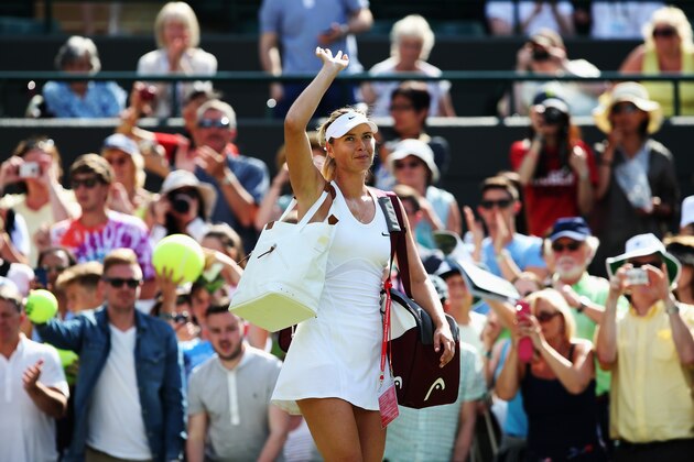 LONDON, ENGLAND - JUNE 24:  Maria Sharapova of Russia waves to the fans after winning her Ladies' Singles first round match against against Samantha Murray of Great Britain on day two of the Wimbledon Lawn Tennis Championships at the All England Lawn Tennis and Croquet Club at Wimbledon on June 24, 2014 in London, England.  (Photo by Jan Kruger/Getty Images)