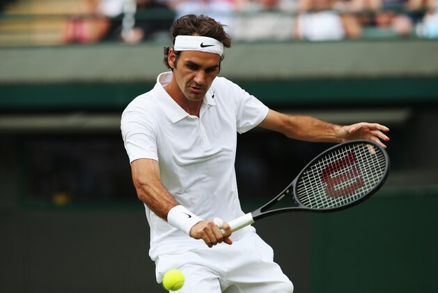 LONDON, ENGLAND - JUNE 24:  Roger Federer of Switzerland in action during his Gentlemen's Singles first round match against Paolo Lorenzi of Italy on day two of the Wimbledon Lawn Tennis Championships at the All England Lawn Tennis and Croquet Club at Wimbledon on June 24, 2014 in London, England.  (Photo by Jan Kruger/Getty Images)