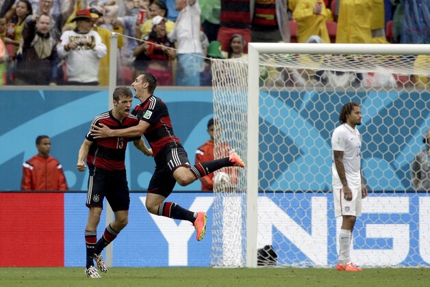 Germany's Thomas Mueller celebrates with his teammate Miroslav Klose, right, after scoring his side's first goal during the group G World Cup soccer match between the United States and Germany at the Arena Pernambuco in Recife, Brazil, Thursday, June 26, 2014. (AP Photo/Ricardo Mazalan)
