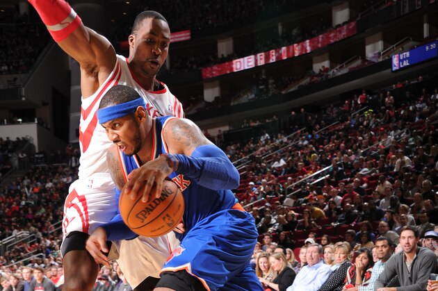 HOUSTON, TX - JANUARY 3:  Carmelo Anthony #7 of the New York Knicks drives against Dwight Howard #12 of the Houston Rockets on January 3, 2014 at the Toyota Center in Houston, Texas. NOTE TO USER: User expressly acknowledges and agrees that, by downloading and or using this photograph, User is consenting to the terms and conditions of the Getty Images License Agreement. Mandatory Copyright Notice: Copyright 2014 NBAE (Photo by Bill Baptist/NBAE via Getty Images)