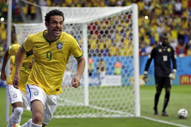 Brazil's Fred celebrates scoring his side's third goal during the group A World Cup soccer match between Cameroon and Brazil at the Estadio Nacional in Brasilia, Brazil, Monday, June 23, 2014. (AP Photo/Dolores Ochoa)