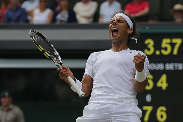 Rafael Nadal of Spain celebrates as he defeated Lukas Rosol of Czech Republic  in their men's singles match on Centre Court at the All England Lawn Tennis Championships in Wimbledon, London, Thursday, June 26, 2014. (AP Photo/Pavel Golovkin)