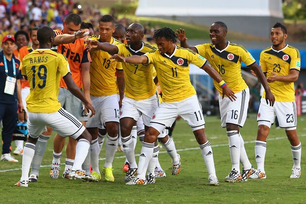 CUIABA, BRAZIL - JUNE 24: Juan Guillermo Cuadrado of Colombia celebrates with teammates scoring his team's first goal after a penalty kick during the 2014 FIFA World Cup Brazil Group C match between Japan and Colombia at Arena Pantanal on June 24, 2014 in Cuiaba, Brazil. (Photo by Mark Kolbe/Getty Images) CUIABA, BRAZIL - JUNE 24: Juan Guillermo Cuadrado of Colombia celebrates with teammates scoring his team's first goal after a penalty kick during the 2014 FIFA World Cup Brazil Group C match between Japan and Colombia at Arena Pantanal on June 24, 2014 in Cuiaba, Brazil. (Photo by Mark Kolbe/Getty Images)