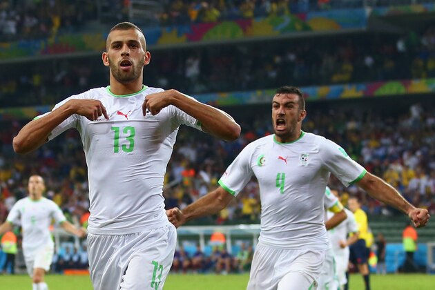 CURITIBA, BRAZIL - JUNE 26:  Islam Slimani of Algeria (L) celebrates scoring his team's first goal with Essaid Belkalem during the 2014 FIFA World Cup Brazil Group H match between Algeria and Russia at Arena da Baixada on June 26, 2014 in Curitiba, Brazil.  (Photo by Julian Finney/Getty Images)