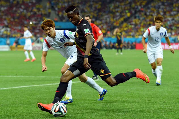 SAO PAULO, BRAZIL - JUNE 26:  Divock Origi of Belgium controls the ball as Kim Young-Gwon of South Korea gives chase during the 2014 FIFA World Cup Brazil Group H match between South Korea and Belgium at Arena de Sao Paulo on June 26, 2014 in Sao Paulo, Brazil.  (Photo by Stu Forster/Getty Images)