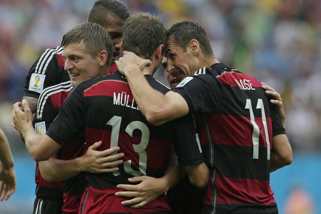 Germany's Miroslav Klose, right, congratulates Thomas Mueller after he scored the opening goal during the group G World Cup soccer match between the USA and Germany at the Arena Pernambuco in Recife, Brazil, Thursday, June 26, 2014. (AP Photo/Petr David Josek)