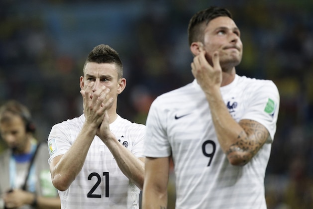 France's Laurent Koscielny, left, and Olivier Giroud leave the pitch after the group E World Cup soccer match between Ecuador and France at the Maracana Stadium in Rio de Janeiro, Brazil, Wednesday, June 25, 2014. France drew 0-0 with 10-man Ecuador to advance to the second round of the World Cup, while the South Americans will be going home from the tournament. (AP Photo/Christophe Ena)