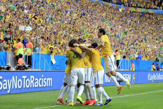 Brazil celebrate after Brazil's Neymar's first goal during the group A World Cup soccer match between Cameroon and Brazil at the Estadio Nacional in Brasilia, Brazil, Monday, June 23, 2014. (AP Photo/Bernat Armangue)