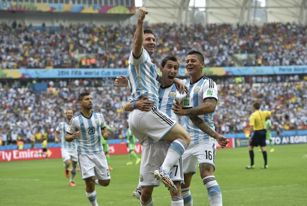 Argentina's Lionel Messi, left, is carried by his teammates Argentina's Angel di Maria (7) and Argentina's Marcos Rojo after scoring his side's first goal during the group F World Cup soccer match between Nigeria and Argentina at the Estadio Beira-Rio in Porto Alegre, Brazil, Wednesday, June 25, 2014. (AP Photo/Martin Meissner)