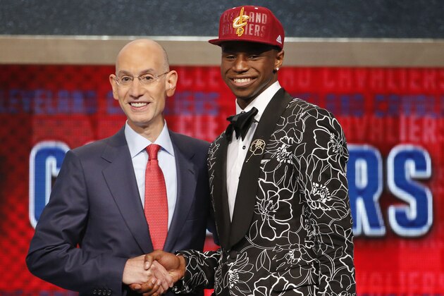 NBA Commissioner Adam Silver, left, congratulates Andrew Wiggins of Kansas who was selected by the Cleveland Cavaliers as the number one pick in the 2014 NBA draft, Thursday, June 26, 2014, in New York. (AP Photo/Jason DeCrow)