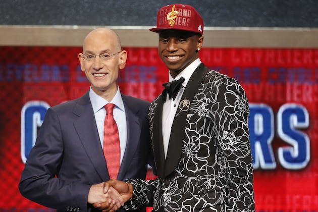NBA Commissioner Adam Silver, left, congratulates Andrew Wiggins of Kansas who was selected by the Cleveland Cavaliers as the number one pick in the 2014 NBA draft, Thursday, June 26, 2014, in New York. (AP Photo/Jason DeCrow)