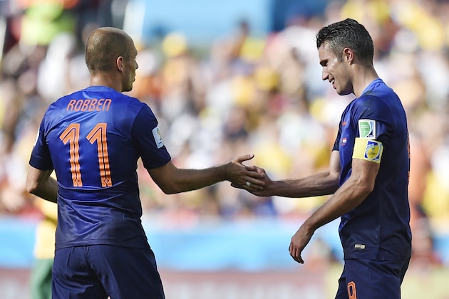 Netherlands' Arjen Robben congratulates Robin van Persie  after he scored his side's second goal during the group B World Cup soccer match between Australia and the Netherlands at the Estadio Beira-Rio in Porto Alegre, Brazil, Wednesday, June 18, 2014.  (AP Photo/Martin Meissner)