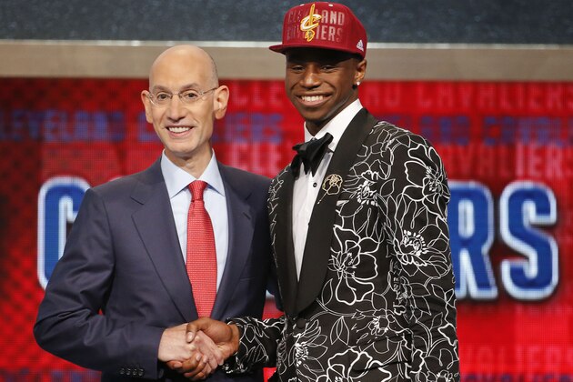 NBA Commissioner Adam Silver, left, congratulates Andrew Wiggins of Kansas who was selected by the Cleveland Cavaliers as the number one pick in the 2014 NBA draft, Thursday, June 26, 2014, in New York. (AP Photo/Jason DeCrow)