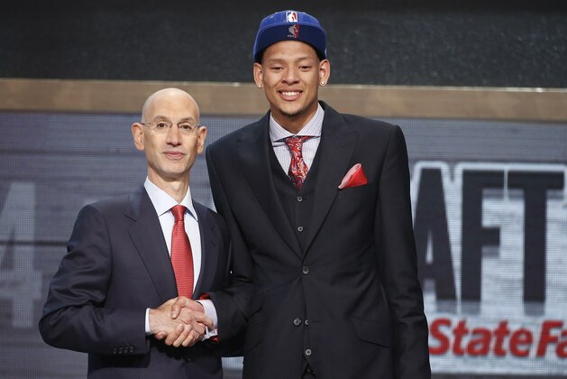 Baylor center Isaiah Austin, right, poses for a photo with NBA Commissioner Adam Silver after being granted ceremonial first round pick during the 2014 NBA draft, Thursday, June 26, 2014, in New York. Austin, who was projected to be a first round selection was diagnosed with Marfan syndrome just four days before the draft. (AP Photo/Jason DeCrow)