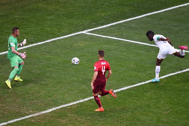 BRASILIA, BRAZIL - JUNE 26:  Asamoah Gyan of Ghana scores his team's first goal past goalkeeper Beto of Portugal during the 2014 FIFA World Cup Brazil Group G match between Portugal and Ghana at Estadio Nacional on June 26, 2014 in Brasilia, Brazil.  (Photo by Christopher Lee/Getty Images)