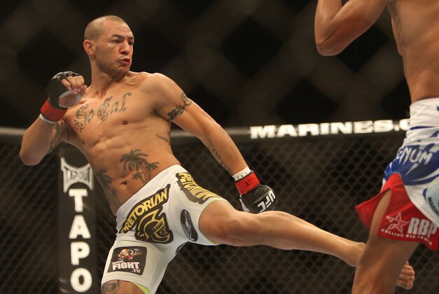 September 22, 2012; Toronto, ON, CANADA; UFC fighter Cub Swanson kicks against UFC fighter Charles Oliveira (right) in the featherweight fight during UFC 152 at the Air Canada Centre. Mandatory Credit: Tom Szczerbowski-USA TODAY Sports