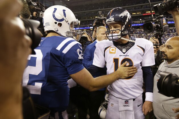 Denver Broncos quarterback Peyton Manning, right, greets Indianapolis Colts quarterback Andrew Luck (12) after an NFL football game, Sunday, Oct. 20, 2013, in Indianapolis. The Colts won 39-33. (AP Photo/Michael Conroy)