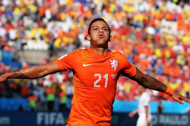 SAO PAULO, BRAZIL - JUNE 23:  Memphis Depay of the Netherlands celebrates scoring his team's second goal during the 2014 FIFA World Cup Brazil Group B match between the Netherlands and Chile at Arena de Sao Paulo on June 23, 2014 in Sao Paulo, Brazil.  (Photo by Dean Mouhtaropoulos/Getty Images)