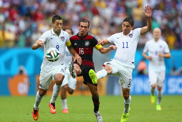 RECIFE, BRAZIL - JUNE 26: Philipp Lahm of Germany is challenged by Clint Dempsey (L) and Alejandro Bedoya of the United States during the 2014 FIFA World Cup Brazil group G match between the United States and Germany at Arena Pernambuco on June 26, 2014 in Recife, Brazil.  (Photo by Michael Steele/Getty Images)