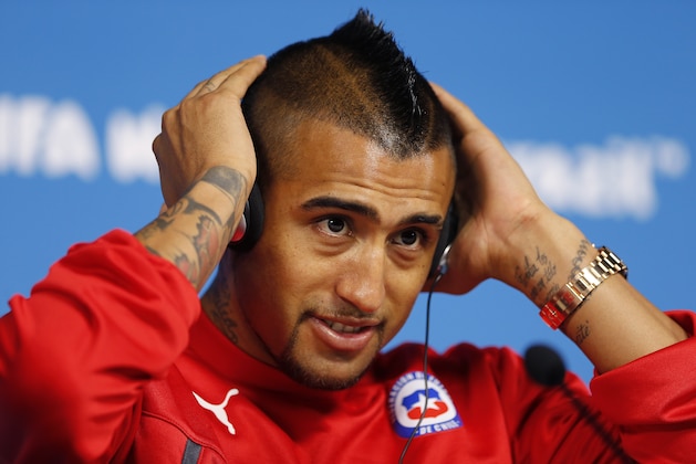 Arturo Vidal of Chile adjusts his headphones during a press conference at the Itaquerao Stadium in Sao Paulo, Brazil, Sunday, June 22, 2014. Chile will play Netherlands in a match that will decide the winner of Group B at the 2014 soccer World Cup. (AP Photo/Wong Maye-E)