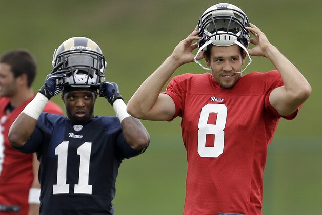 St. Louis Rams wide receiver Tavon Austin, left, and quarterback Sam Bradford put on the helmets during training camp at the NFL football team's practice facility Monday, July 29, 2013, in St. Louis. (AP Photo/Jeff Roberson)