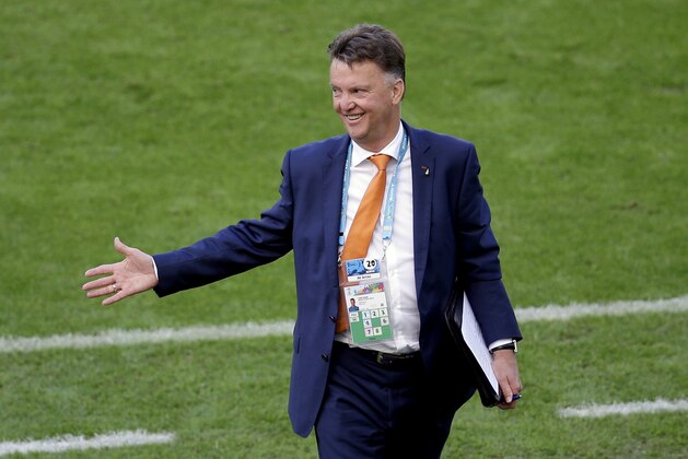 Netherlands' head coach Louis van Gaal smiles after Netherlands' Arjen Robben scored the opening goal during the group B World Cup soccer match between Australia and the Netherlands at the Estadio Beira-Rio in Porto Alegre, Brazil, Wednesday, June 18, 2014. (AP Photo/Michael Sohn)