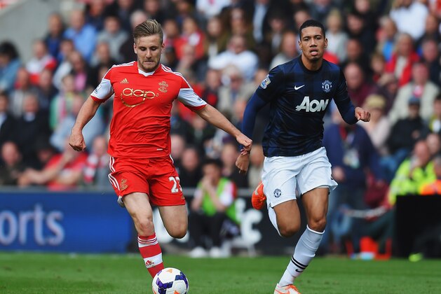 SOUTHAMPTON, ENGLAND - MAY 11:  (L-R) Luke Shaw of Southampton holds off Chris Smalling of Manchester United during the Barclays Premier League match between Southampton and Manchester United at St Mary's Stadium on May 11, 2014 in Southampton, England.  (Photo by Mike Hewitt/Getty Images)