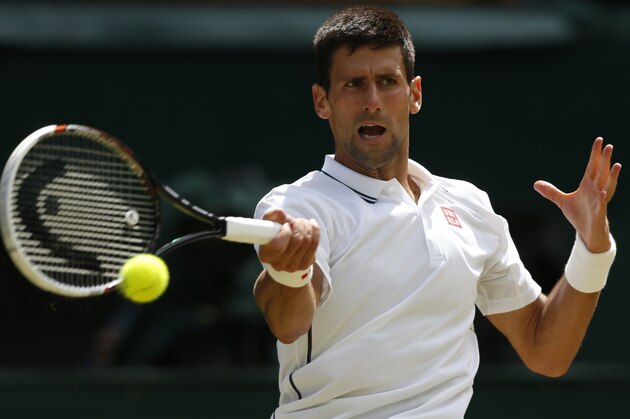 Novak Djokovic of Serbia plays a return to Gilles Simon of France during their men's singles match at the All England Lawn Tennis Championships in Wimbledon, London, Friday, June 27, 2014. (AP Photo/Sang Tan)