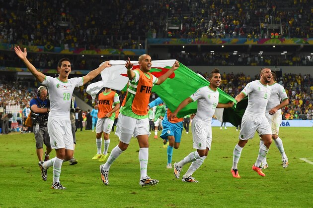 CURITIBA, BRAZIL - JUNE 26: Aissa Mandi (L) and Madjid Bougherra of Algeria celebrate with teammates after a 1-1 tie during the 2014 FIFA World Cup Brazil Group H match between Algeria and Russia at Arena da Baixada on June 26, 2014 in Curitiba, Brazil. (Photo by Matthias Hangst/Getty Images) CURITIBA, BRAZIL - JUNE 26: Aissa Mandi (L) and Madjid Bougherra of Algeria celebrate with teammates after a 1-1 tie during the 2014 FIFA World Cup Brazil Group H match between Algeria and Russia at Arena da Baixada on June 26, 2014 in Curitiba, Brazil. (Photo by Matthias Hangst/Getty Images)