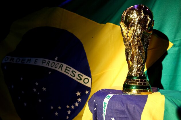 PORTO SEGURO, BRAZIL - JUNE 12:  A replica of the FIFA world cup trophy is displayed during the Group A match between Brazil and Croatia on June 12, 2014 in Porto Seguro, Brazil.  (Photo by Martin Rose/Getty Images)