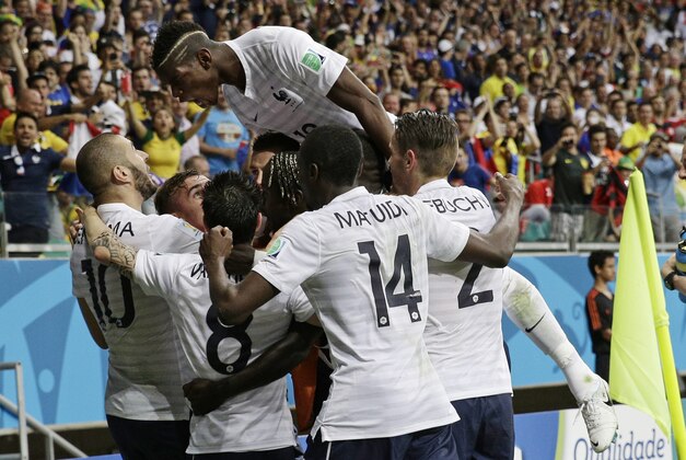 French players celebrate after France's Karim Benzema, left,  scored his side's fourth goal during the group E World Cup soccer match between Switzerland and France at the Arena Fonte Nova in Salvador, Brazil, Friday, June 20, 2014.    (AP Photo/Christophe Ena)